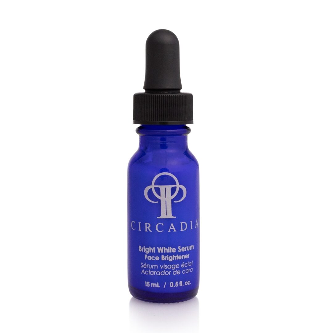 6802b35ca43d3_bright-White-.Seru A blue bottle of serum is sitting on the table.