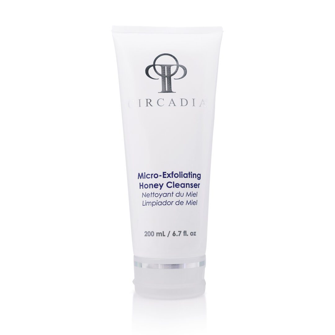 6802b35d1d639_Micro-Exfoliating Honey Cleanser A white tube of cream sitting on top of a table.