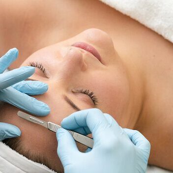 A woman getting her face waxed at the spa