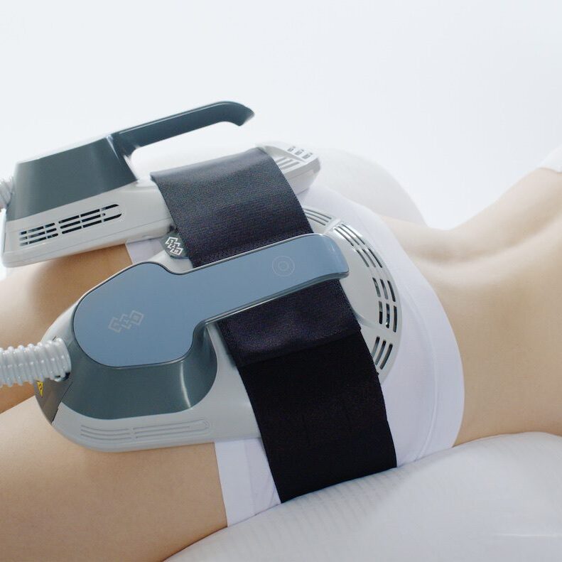 EMS + NEO - Electrical Muscle Stimulation A person is holding on to the arm of someone.