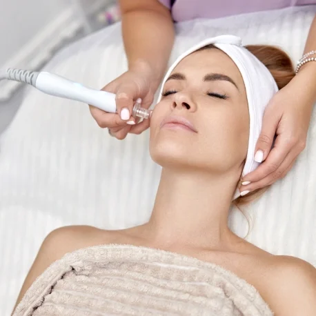 A woman getting her face waxed at the spa