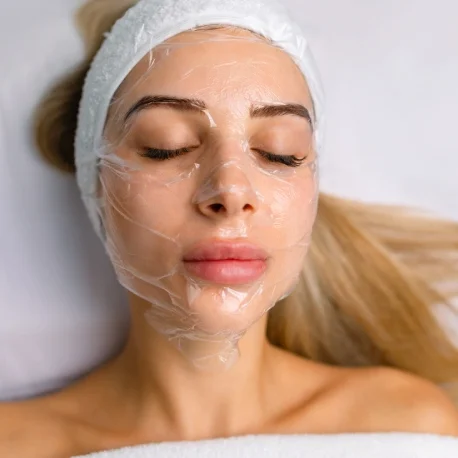 A woman with white hair and a bandage on her head.