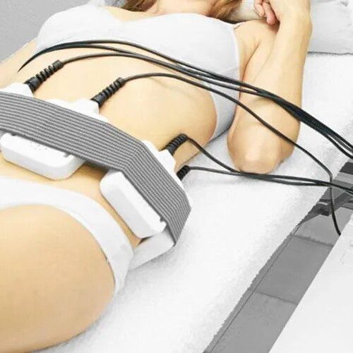 Lipo Lite A woman laying on her stomach with multiple wires attached to it.