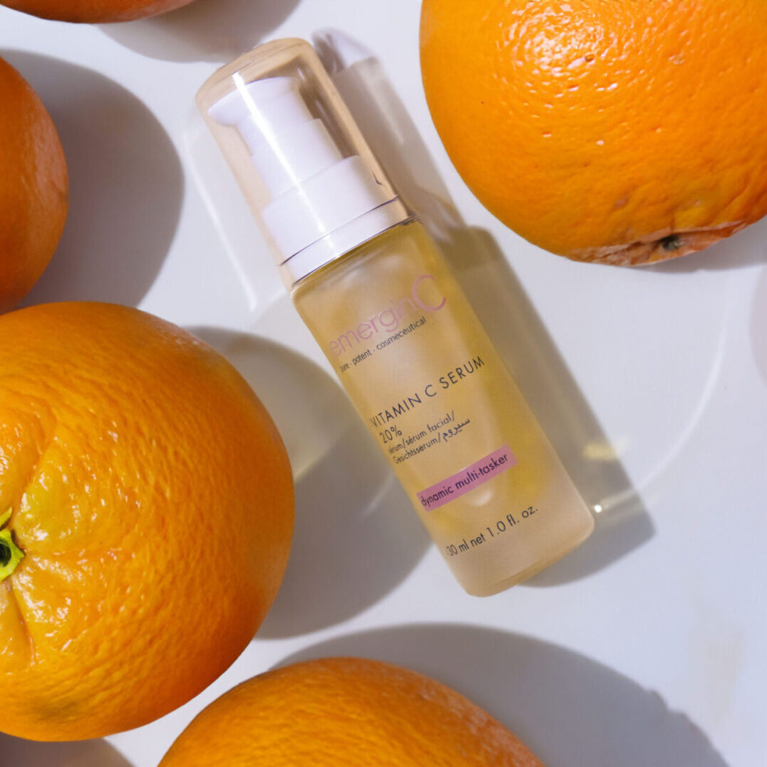Vitamin C Radiance Facial A bottle of serum next to some oranges.